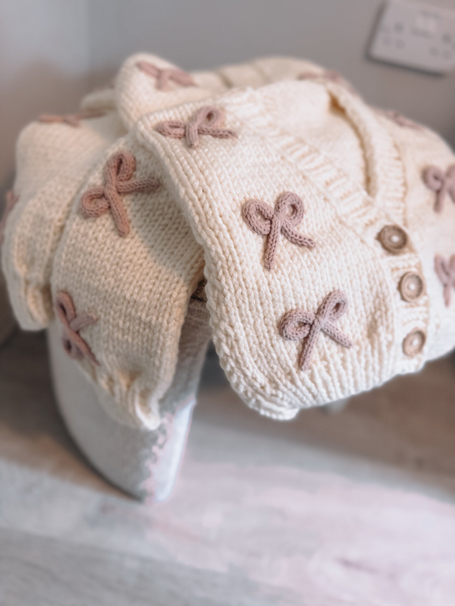 Cream and dusky pink bow hand knitted cardigan
