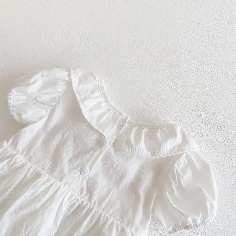 White romper with pink embroidery detail