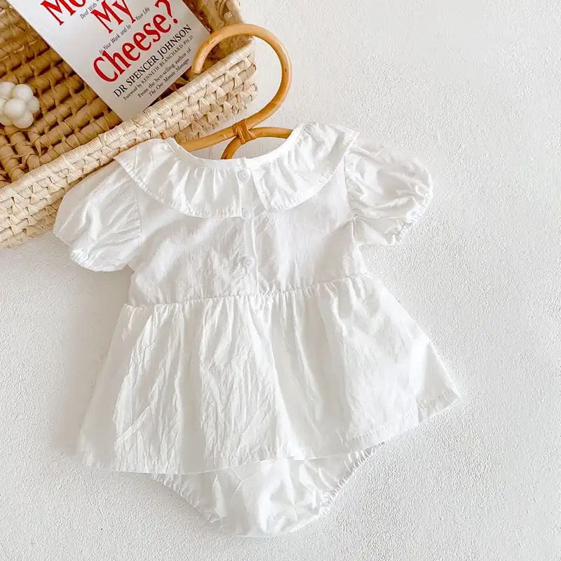 White romper with pink embroidery detail