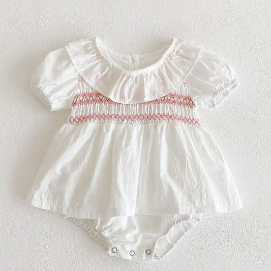 White romper with pink embroidery detail